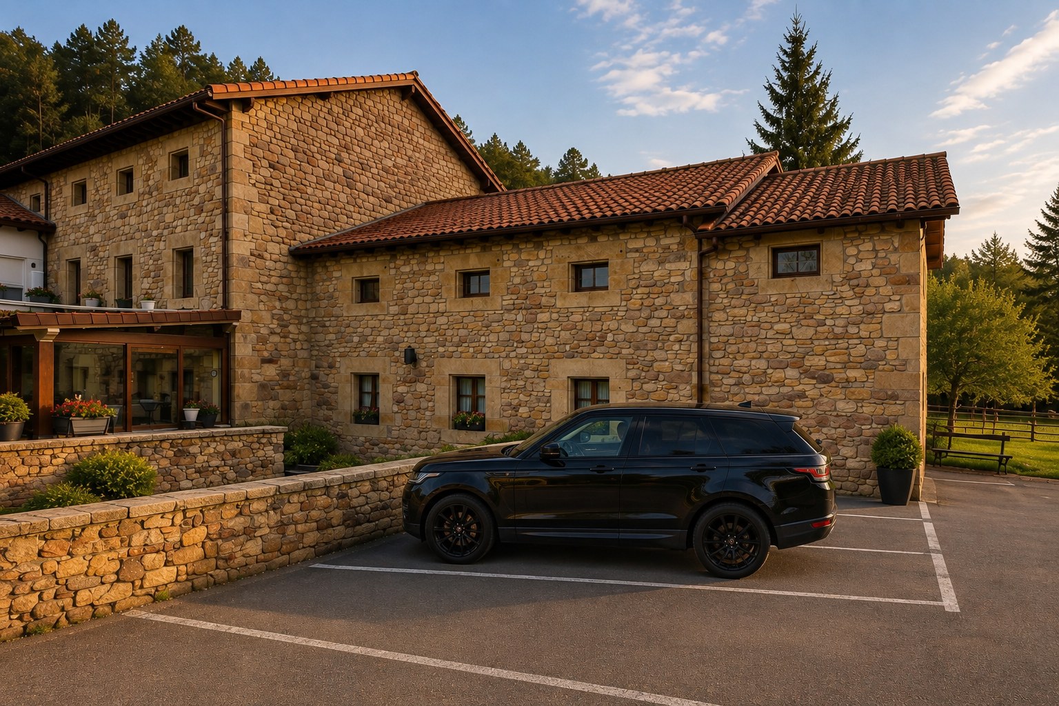 Fachada de piedra y aparcamiento privado del Hotel Paraíso del Pas, Cantabria